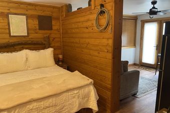 Bedroom interior of Tomboy Lodge 138 featuring a king bed and wooden decor.