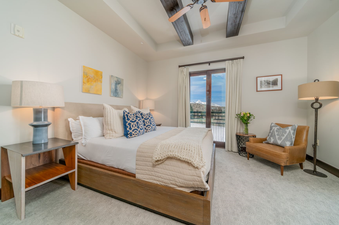 Lumiere Studio Deluxe features a plush bed, a beautiful view of the mountains, and a relaxing seating area.