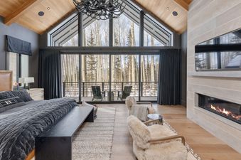 The master bedroom at Lone Star Lodge offers a cozy respite with stunning views.