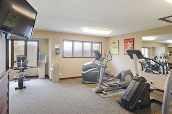 A modern fitness center at The Ranch at Steamboat RA510 with various exercise machines, large windows, and a wall-mounted TV.