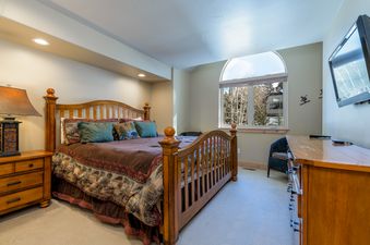 The bedroom in Aspenglow Chalet Above Downtown features a comfortable bed and serene ambiance.