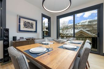 The dining area in Stone Creek Chalet at The Aspens boasts a contemporary aesthetic and stunning views.
