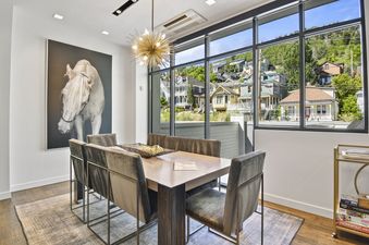 The dining area in Parkite 34 features a large window with a view of the surrounding mountain town.