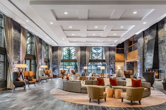 A spacious and elegantly designed lounge area within The Westin Resort One Bedroom Suite, featuring comfortable seating arrangements, large windows with natural light, and a prominent fireplace.