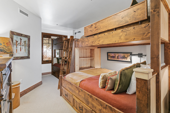 Grand Lodge 3 Bedroom Deluxe 304 features a bedroom with a bunk bed.  The bunk bed has a full-size bottom bed and a twin-size top bed.