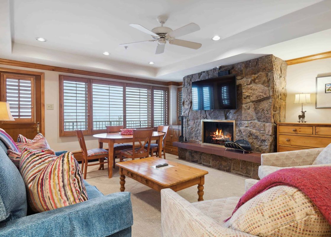 The living area of Lodge Tower 686 2 Bedroom features comfortable seating and a stone fireplace.