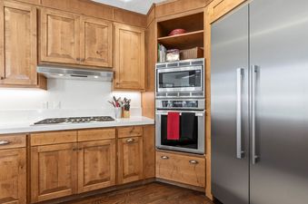 Kitchen with stainless steel appliances and wooden cabinets.