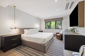 The bedroom at Lodge Tower 699 features a luxurious bed, stylish furnishings, and a serene ambiance.