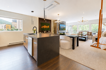 The open-concept kitchen, dining, and living area in Montaneros 302.