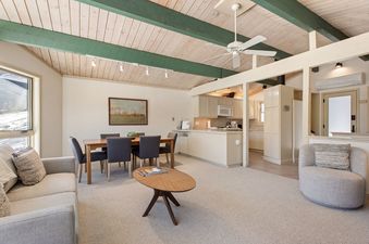 An open-plan living, dining, and kitchen area in Shadow Mountain Unit 19 with vaulted wood ceilings.