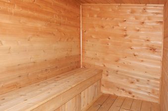 A close-up view of the interior of a traditional wooden sauna with benches.