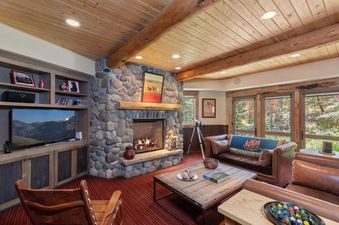 The inviting living room at 116 Hang Glider Dr with a stone fireplace and wood accents.