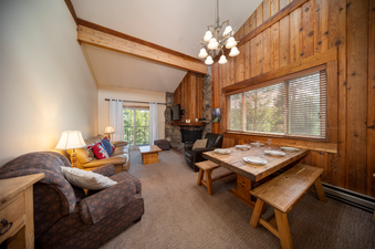 The living area of Beaver Village 1134 features a plush sofa, inviting armchairs, and a warm fireplace, creating a cozy and welcoming atmosphere.
