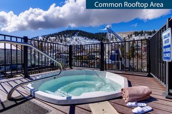 The common rooftop area of Rio Grande 301 features a hot tub with mountain views, perfect for relaxation.