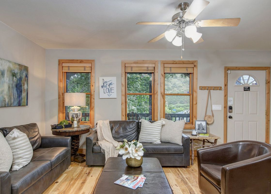 The living room at Abode Mountainside is warm and inviting.