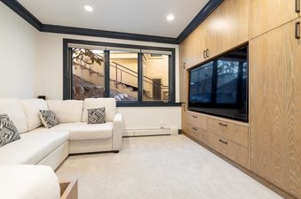Cozy living room in Stone Creek Chalet at The Aspens with a comfortable white sofa.