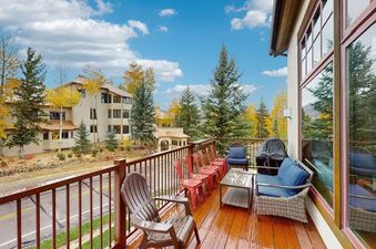 Spacious wooden deck of EagleRidge Townhomes 1455 with cozy seating options and scenic surrounding views.