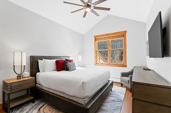 A bedroom in Red Hawk Townhome 2349 features a king-sized bed and a television.