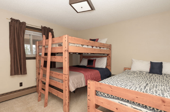 The bedroom features comfortable beds with ample sleeping arrangements and tasteful decor.