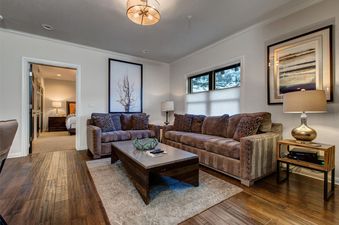 Comfortable lounge area with sofas, coffee table, and artwork.