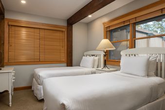 A cozy bedroom at Top of the Village Trails 101 with two twin beds.