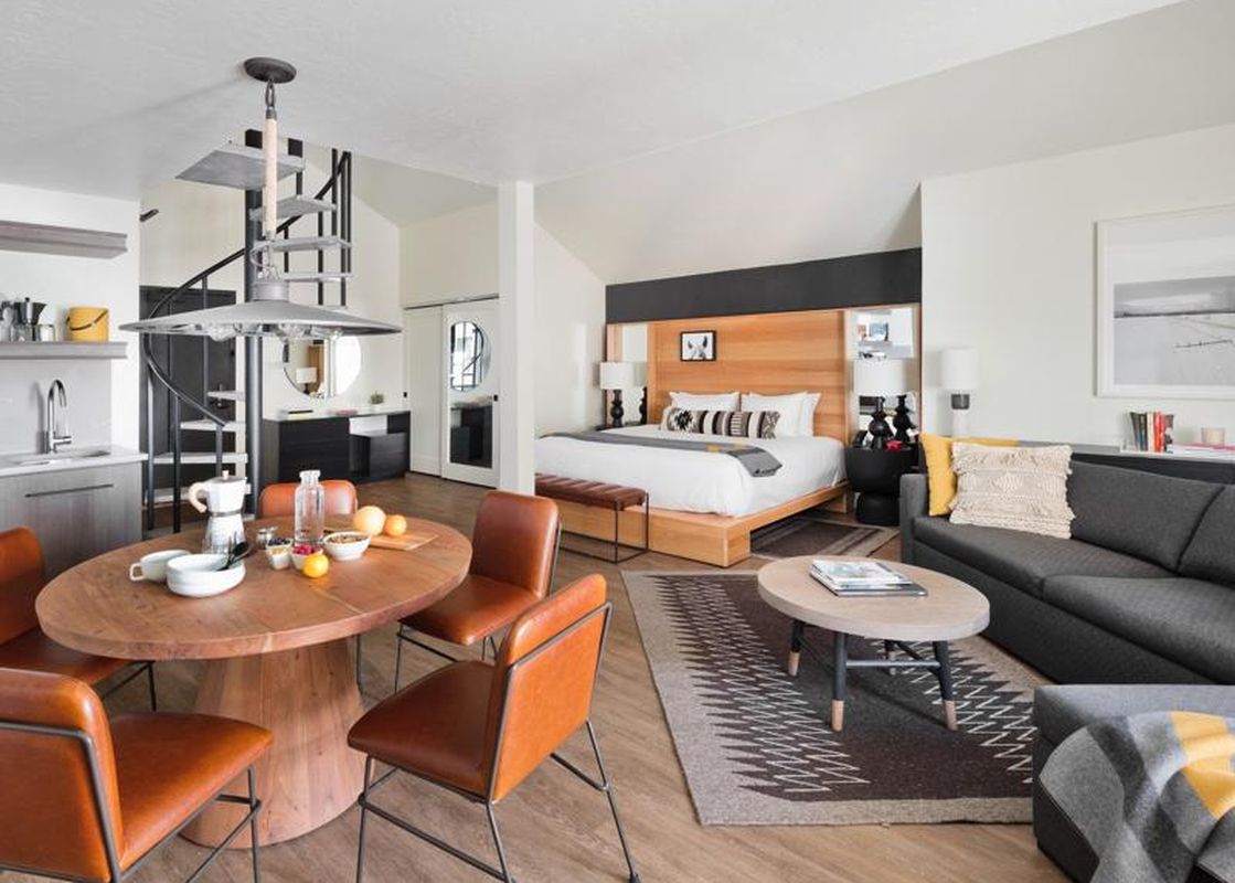 Contemporary open-concept dining, living, and bedroom areas in the Gravity Haus JH Premium Loft Suite.