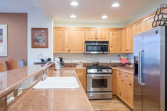 The kitchen of Bear Creek Lodge 302 is well-equipped with stainless steel appliances and modern cabinetry.