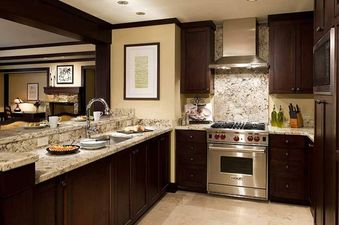 Modern kitchen with granite countertops and stainless steel appliances in The Star Two Bedroom Residence.