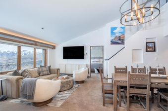 An open-concept living and dining area in Penthouse At The Peaks 826 showcases modern design and comfortable seating.