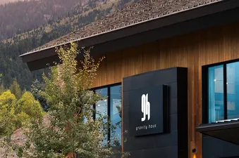 Exterior view of Gravity Haus JH Deluxe Suite with a mountain background.