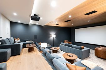 Private home theater at Deer Valley Luxe at Moonshadow with comfortable tiered seating and a large projection screen.