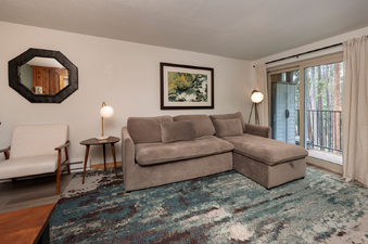The living room at Beaver Village 514 is decorated with a comfortable sofa and unique decor.