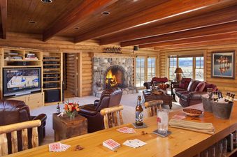 The Grand Teton Vista features a cozy living area with a stone fireplace and a bar.
