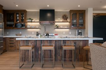 Luxurious modern rustic kitchen at Emerald Mountain One Steamboat Place 702 with marble island and wood cabinetry.
