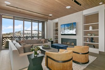 The Tower Club 6's luxurious living room features a fireplace, comfortable seating, and a stunning view.
