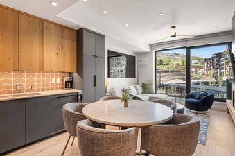 Electric Pass Lodge 207's dining area features a large window with a mountain view.