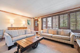 The living room in Lodge Tower 299 3BR has two sofas and unique wood coffee table.