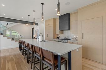 A modern kitchen with a large island and bar seating at Sunrise Ridge at Canyons.