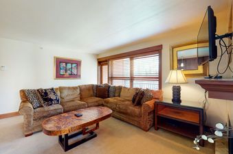 Living room with a couch, coffee table, and fireplace.