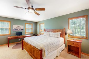 Bedroom at Big Moose Lodge featuring a wooden bed frame and matching furnishings.
