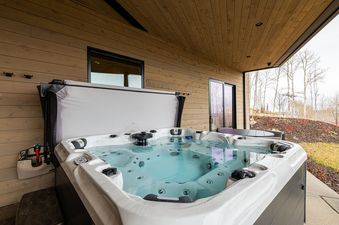 An outdoor hot tub with clear water on the patio at Deer Valley Luxe at Moonshadow.