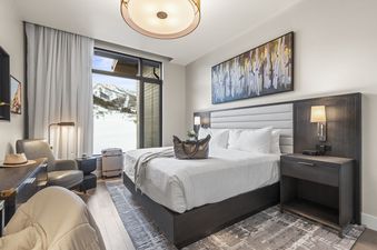 The bedroom in the Abode at Deer Valley East features a plush bed and a view of the snowy slopes.
