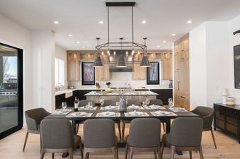 The dining area is furnished with a large dining table and modern chairs.