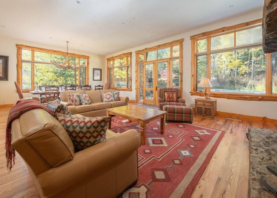 Living area of Granite Ridge Lodge 6 with leather sofas and large scenic windows.
