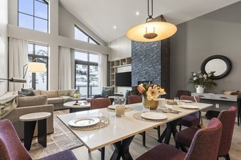 The dining area in Abode at Deer Valley East features a large table set for a meal.