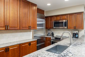 The kitchen in Montaneros 416 features stainless steel appliances and granite countertops.