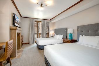 The bedroom in Abode at First Dawn B features two queen beds and a fireplace.