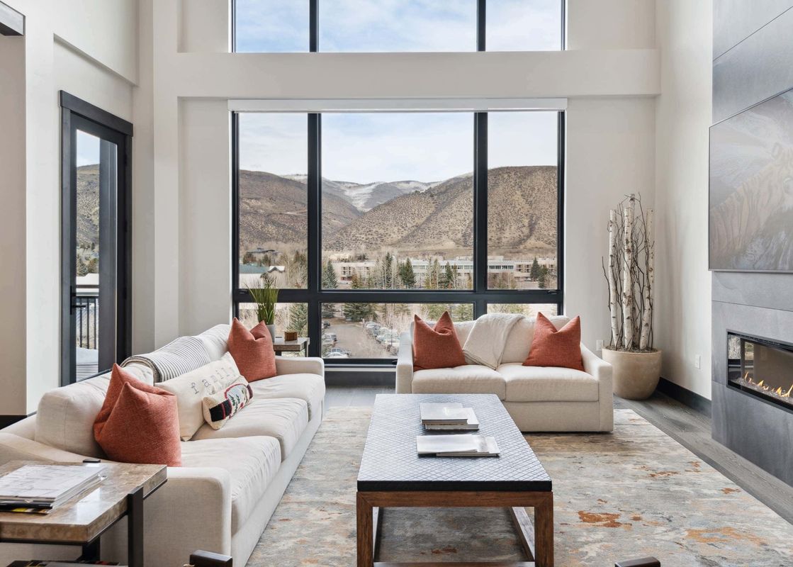Bright living room in One Riverfront Condo 503 with views of the mountains.