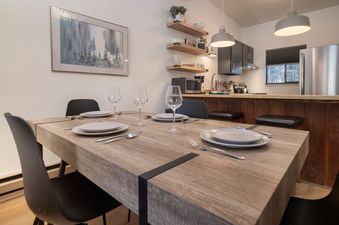 A close-up view of the set dining table in Beaver Village 332, showcasing the modern decor and functional kitchen bar.