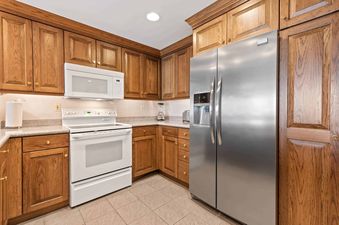The kitchen in Lodge Tower 378 features wood cabinets and stainless steel appliances.
